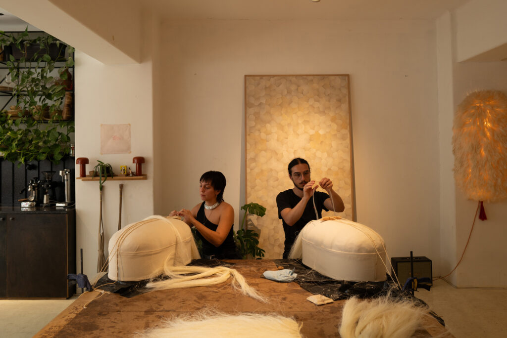 Two people working on artwork for FONDA